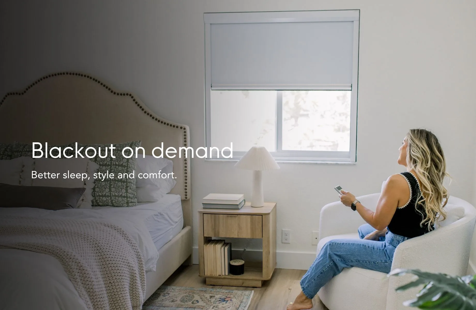 Blackout on demand — better sleep, style and comfort, shown in a bedroom with the shade lowered by remote