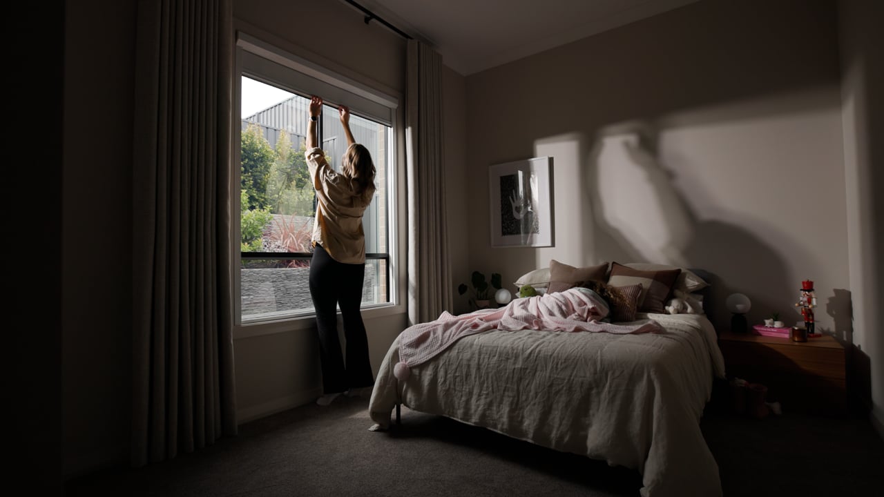 A bedroom with UBlockout down, no light down either side of the shade